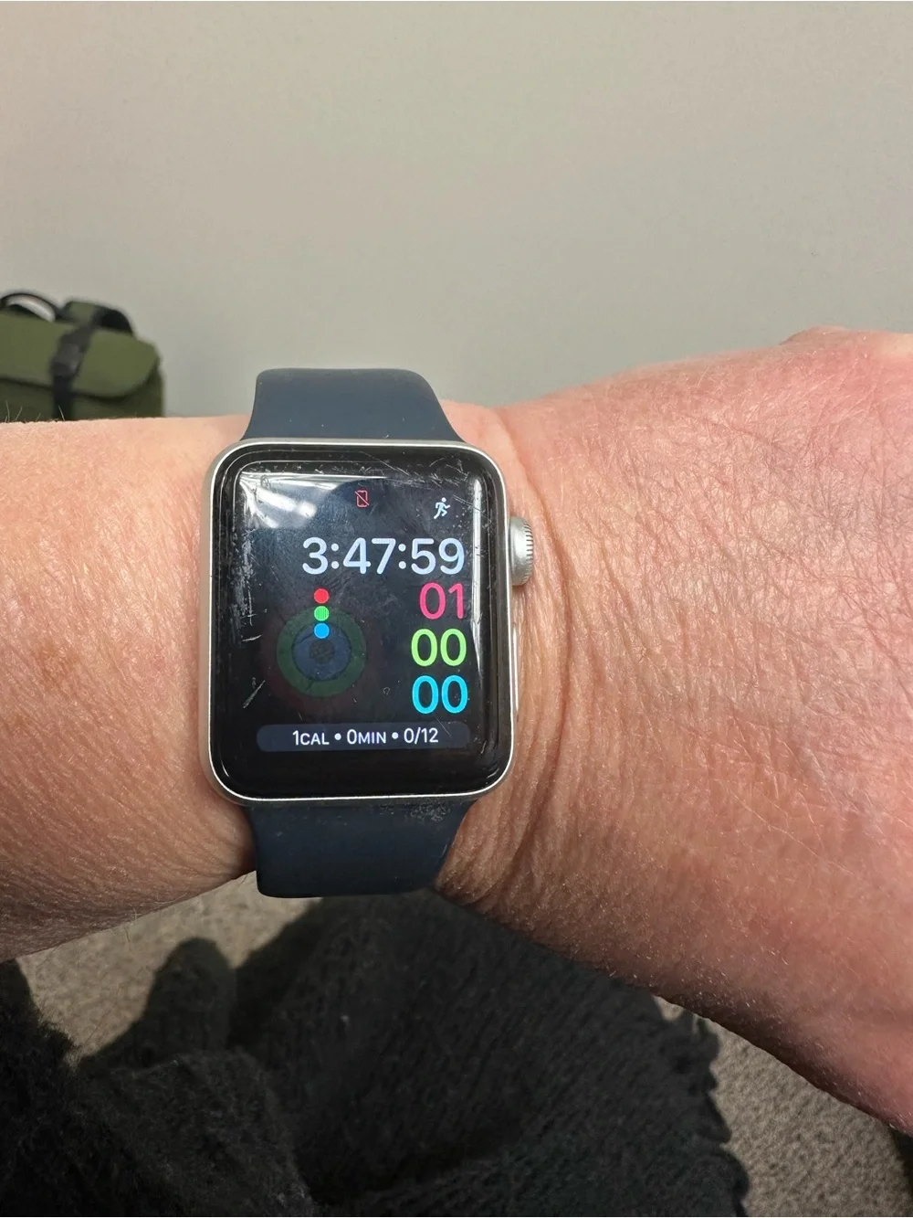 Apple Watch Series 3 with Black and White bands and charging cable.